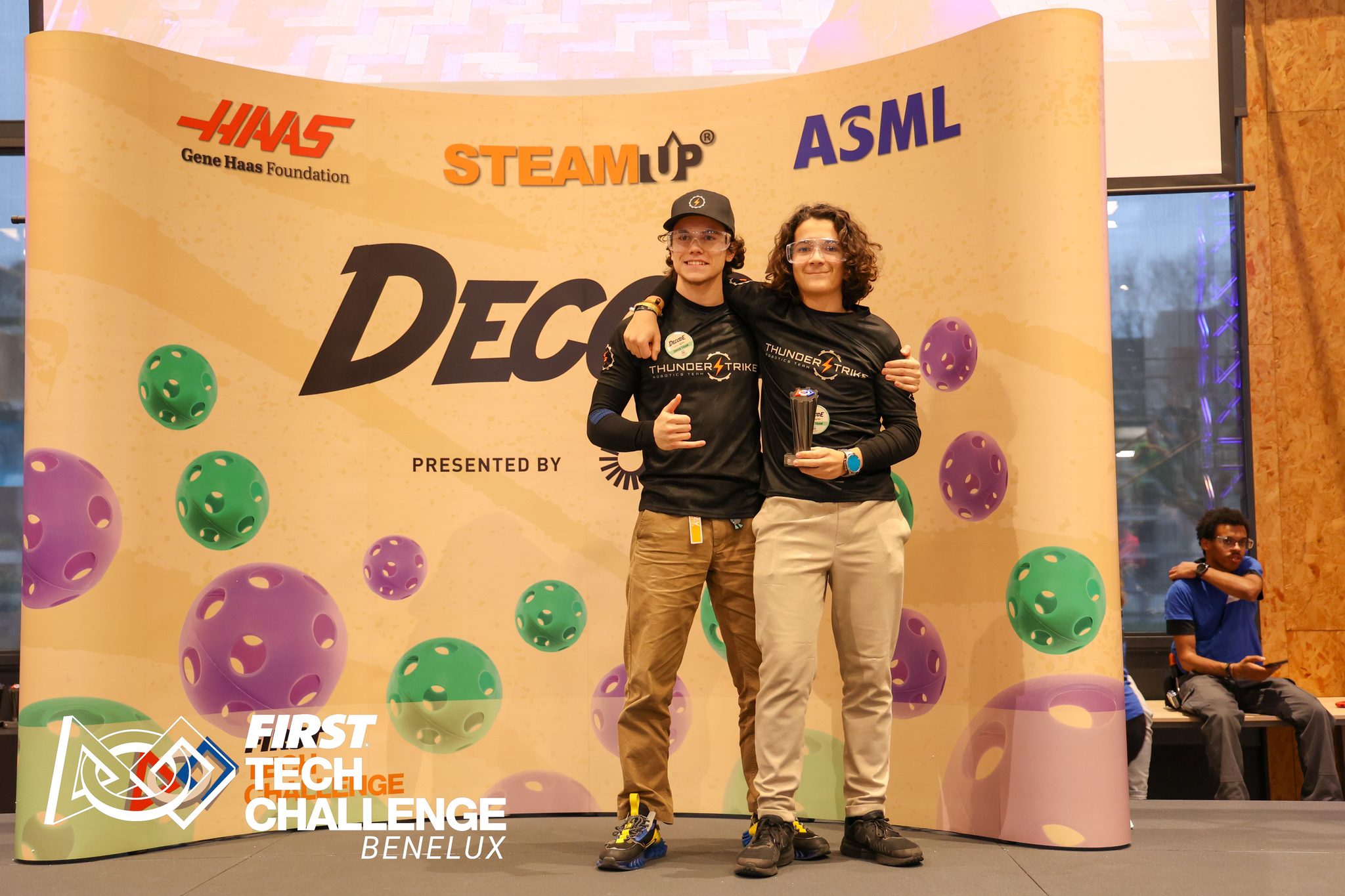 Two Thunderstrike members with a trophy on the awards stage at the FTC Benelux Helmond Qualifier