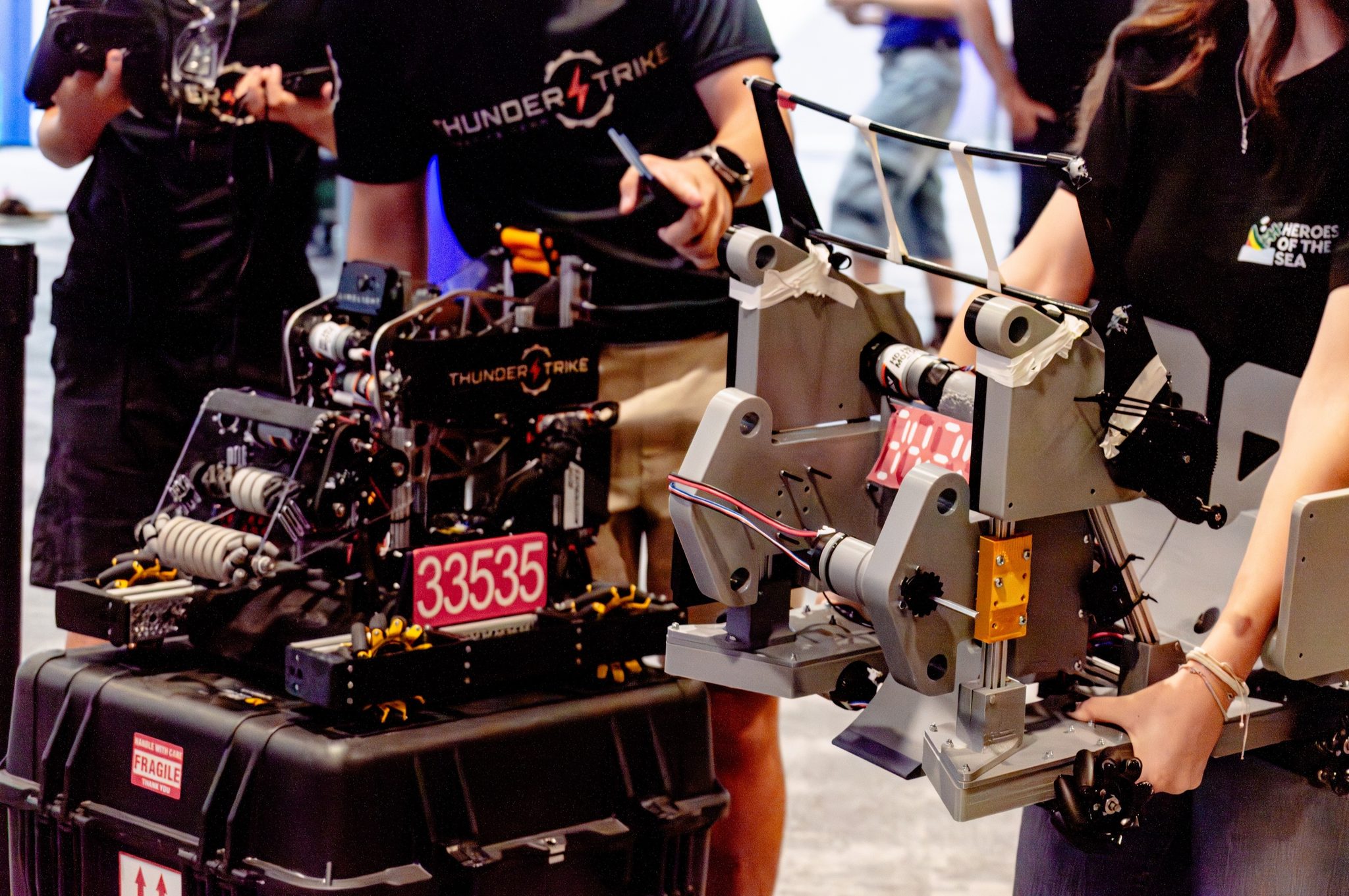 Thunderstrike robot 33535 up close, with team members in Thunderstrike shirts behind it