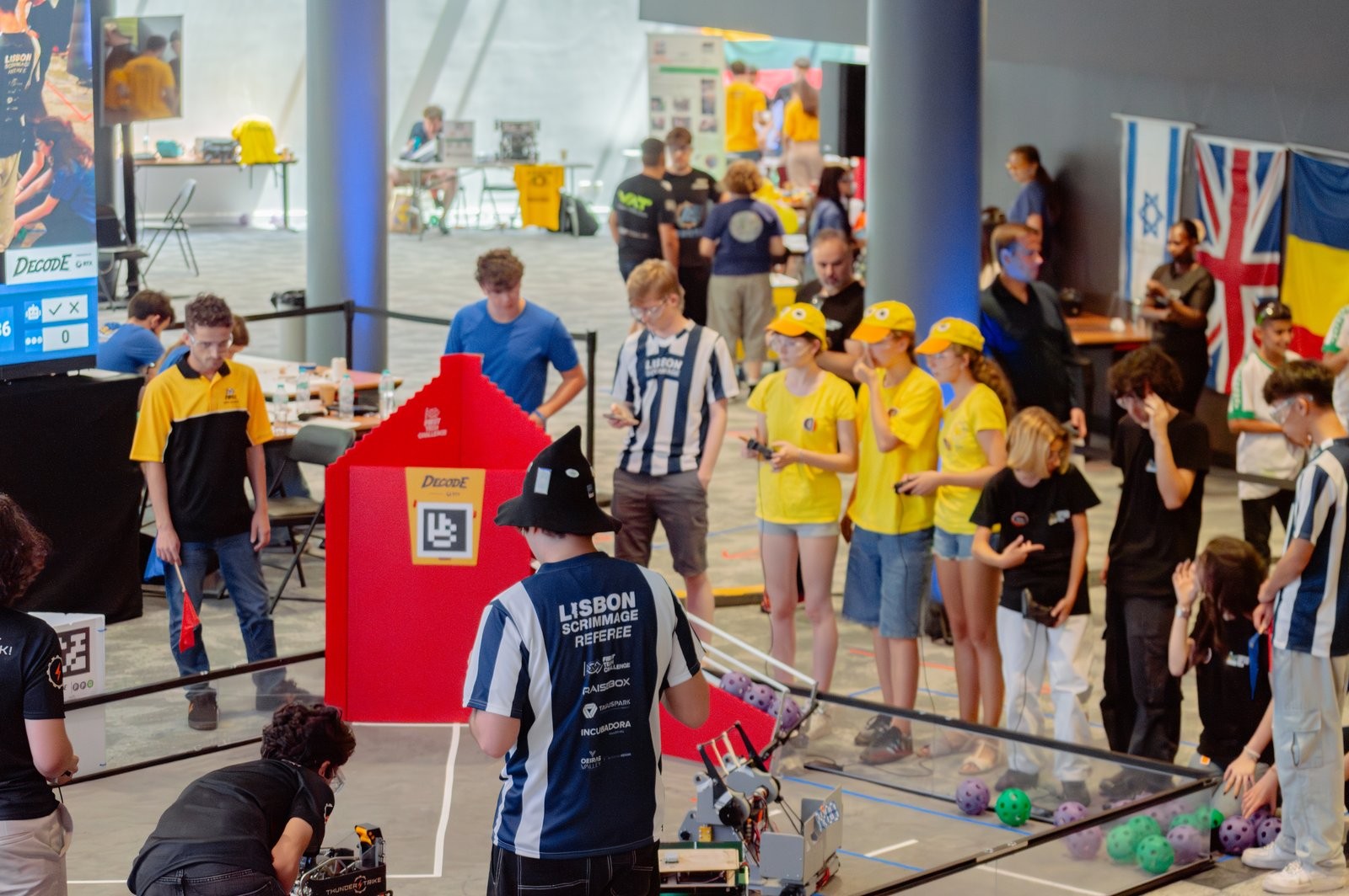 The match floor at the Lisbon Scrimmage: the DECODE field, a referee, and teams watching