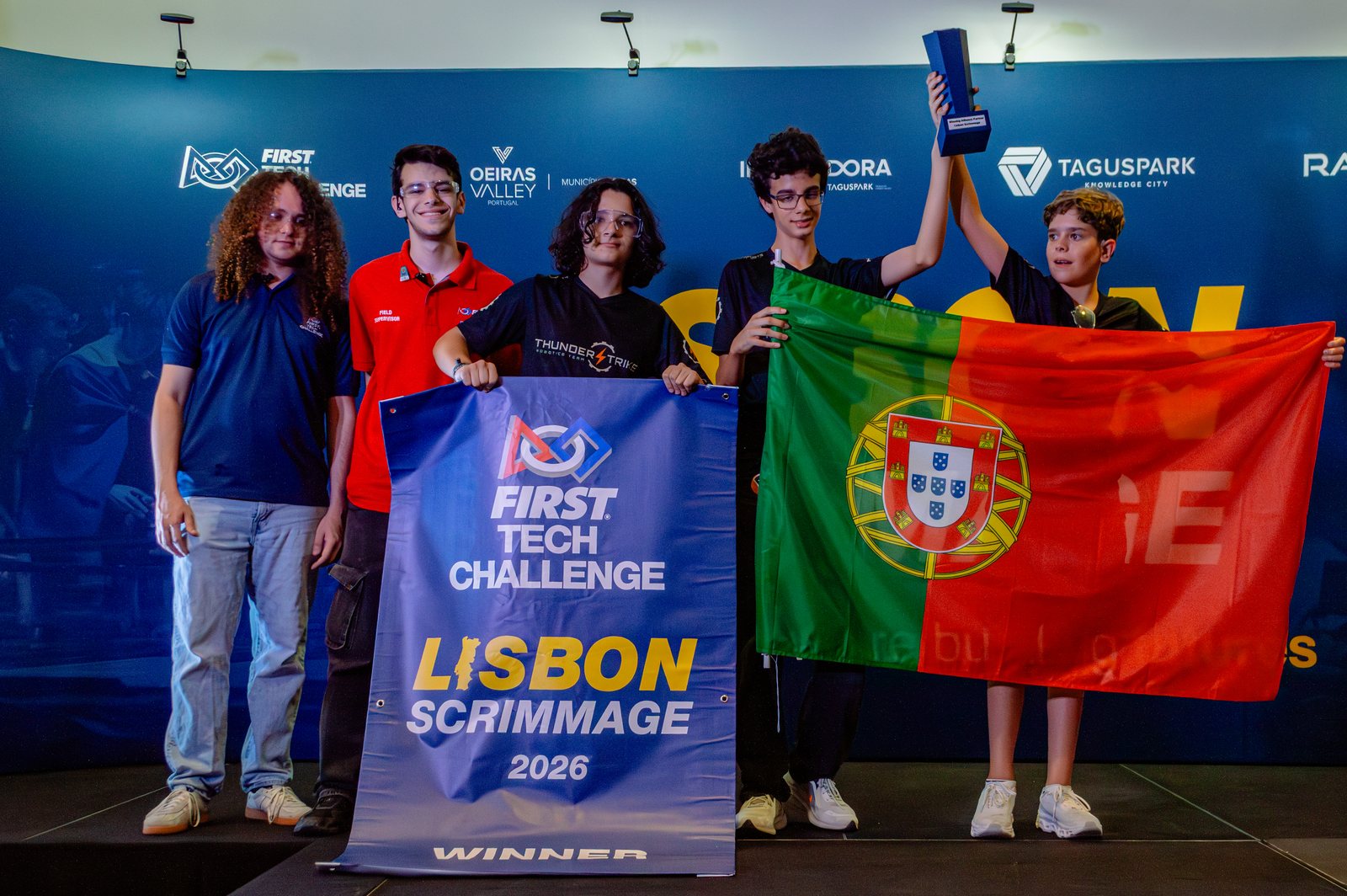 Teams on the awards stage with their national flags