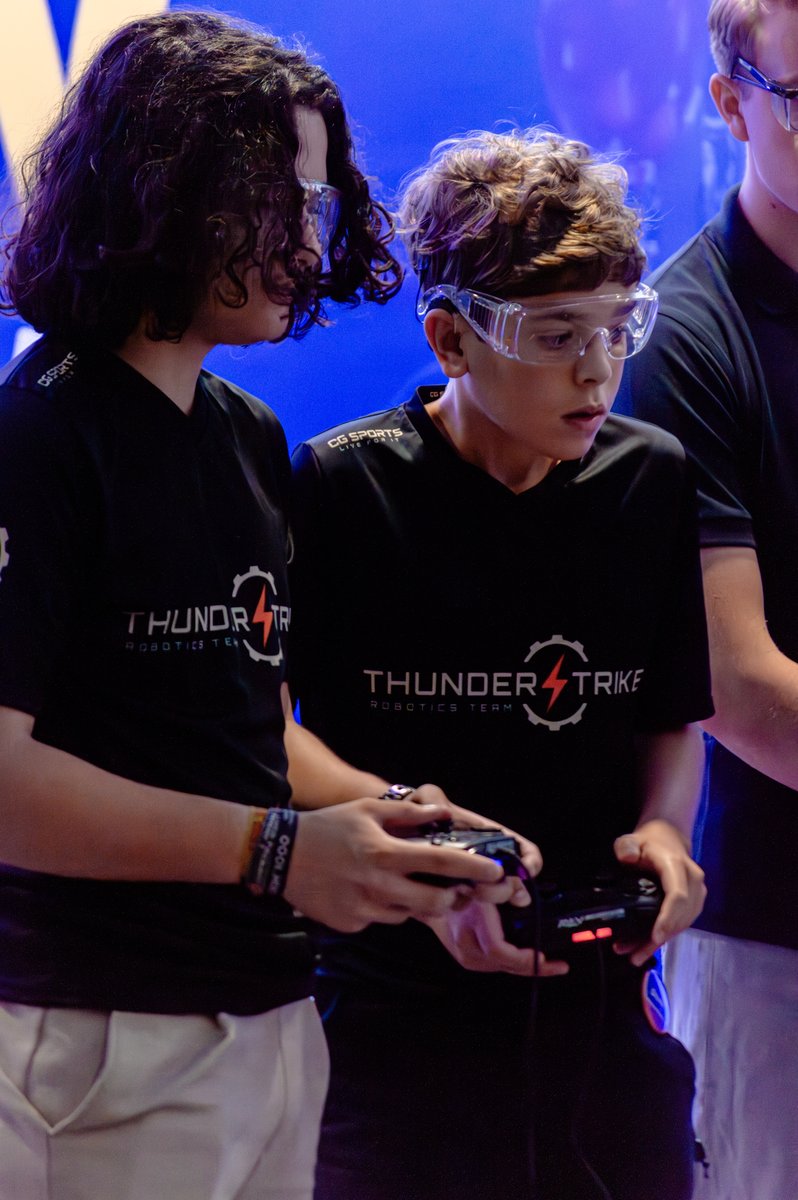 Two Thunderstrike students driving the robot with hand controllers